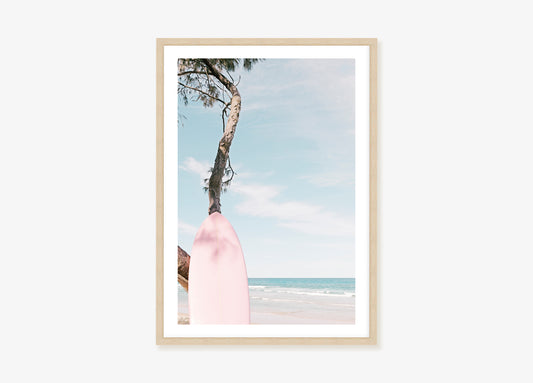 a picture of a pink surfboard on the beach